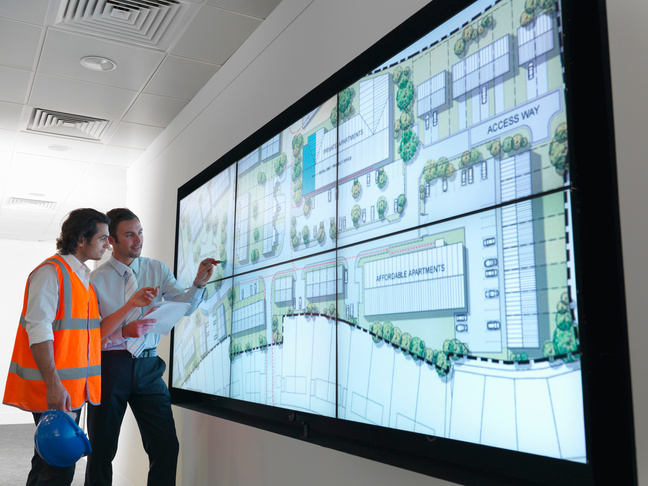 Town planners work at plans on screen